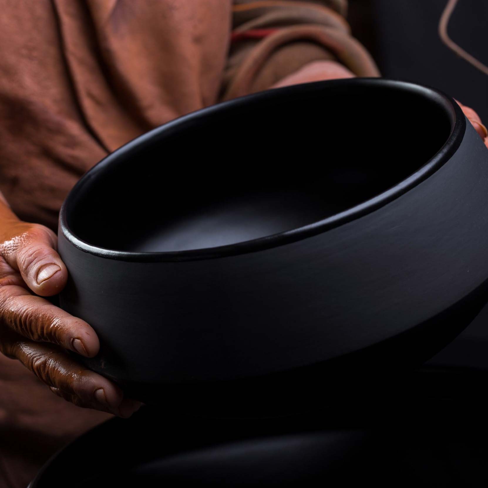 CEO Miks Balodis, holding a large salad bowl from collection Earth.