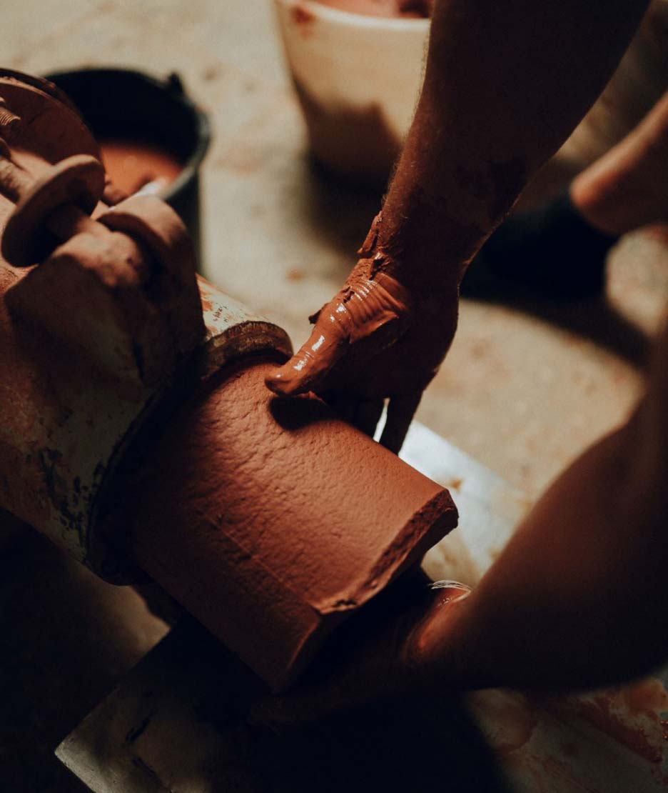 Clay forming through a special machine that forms it into a cylinder 