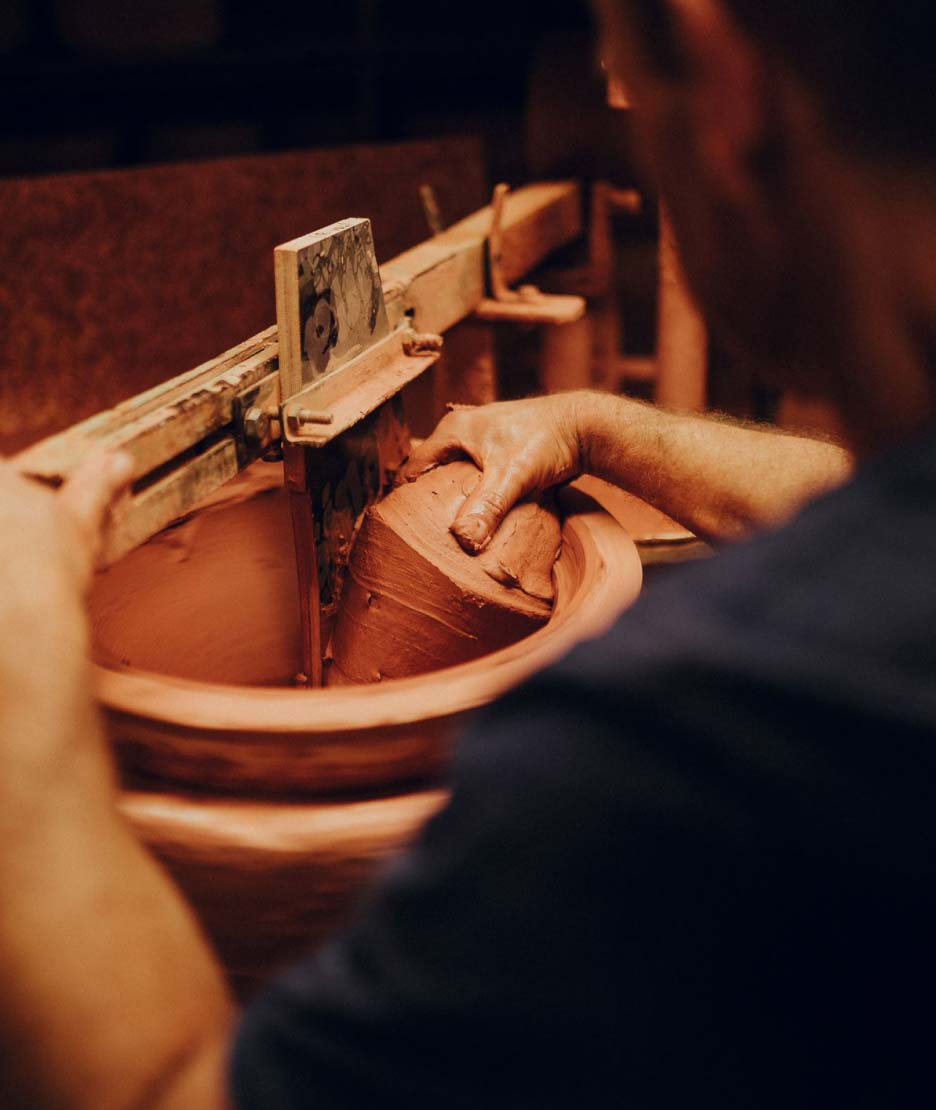 A man jiggering terracotta clay