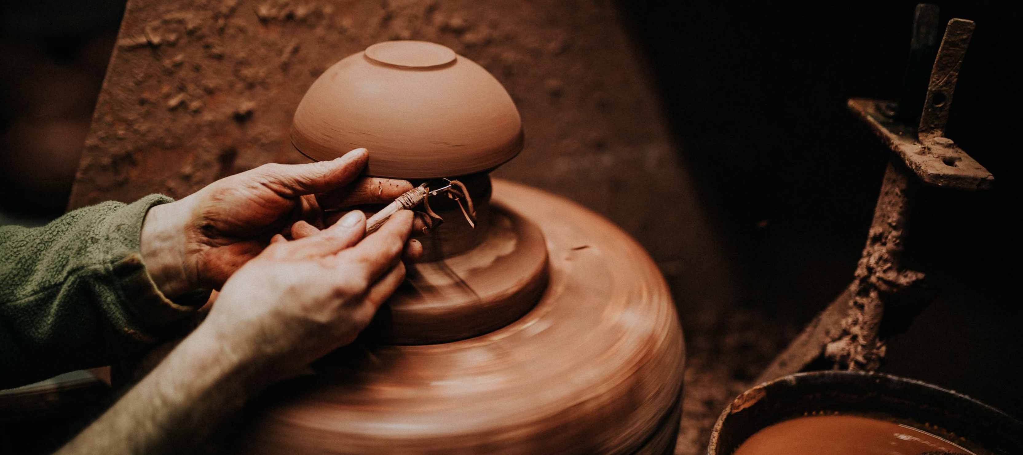 Shaping tradition with skilled hands—smoothing the bowl's rim with care and precision